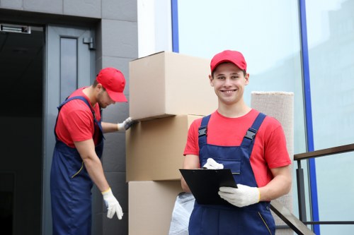Moving team handling furniture near Stockwell streets