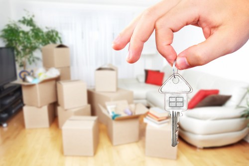 Professional movers carrying furniture from a Stockwell flat