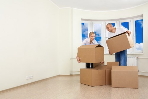 Removal team handling boxes and furniture during a house move
