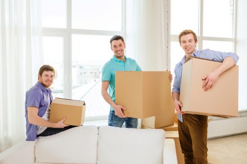 Household moving team handling boxes and furniture in Stockwell
