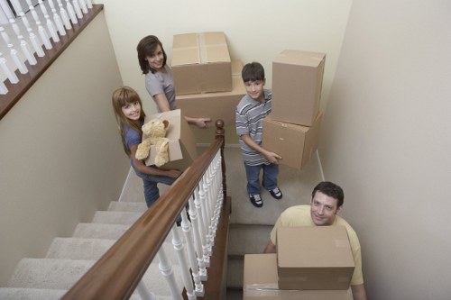 Packed boxes and furniture being loaded into a moving van